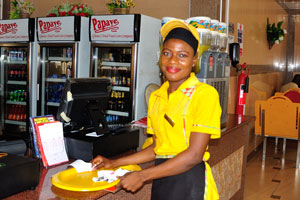 A good-looking female employee is in Papaye Fast Foods