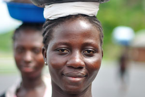 A pretty Ghanaian girl is portrayed with a basin on the head