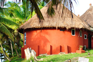 A fascinating house of red brick color with a thatched roof is fabulous