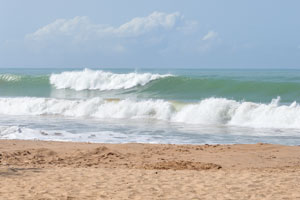 Amazing foamy waves of the Axim Beach are striking in their emerald beauty