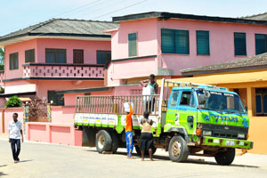 The truck is parked on the main street of fishing village