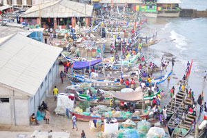 Fishing boats are at the foot of Cape Coast castle