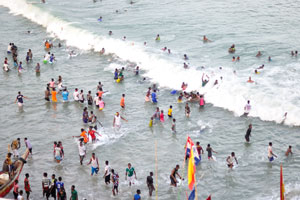 People are having fun time in the waves of Gulf of Guinea