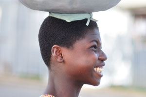 A charming Ghanaian girl wears the bowl on the head
