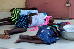 In the noon, young African girls are sleeping in the shade on the Prempeh II avenue