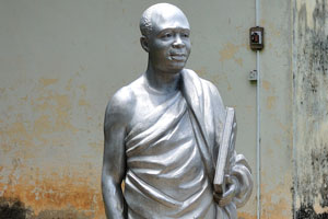A statue of a wise African man is in the National Cultural Center complex