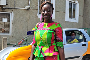 A fine-looking Ghanaian woman is in the bright colourful dress