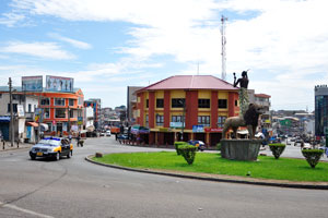 A roundabout with a lion statue as seen from Wesley Methodist Cathedral