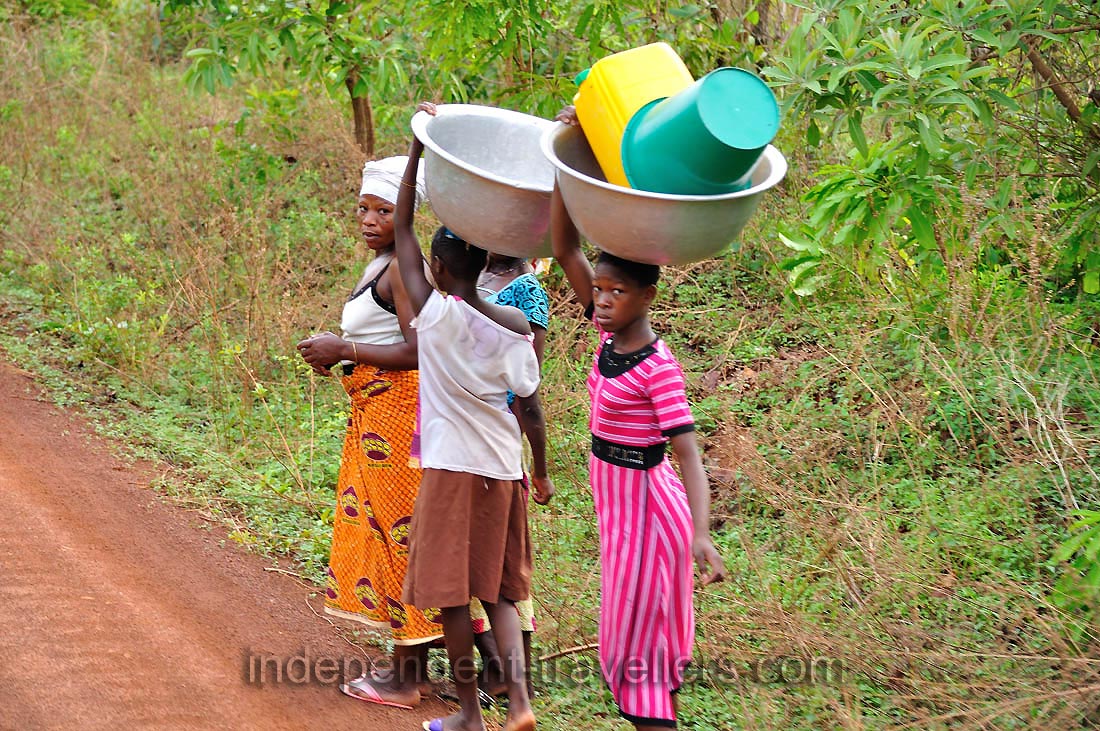 Local women carry the huge bowls on the heads