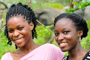 Two beautiful Ghanaian girls are on the background of an elephant