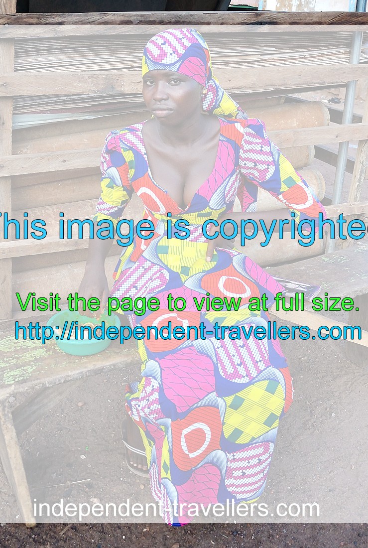 A stunning Ghanaian woman with big breasts is dressed in a beautiful African dress