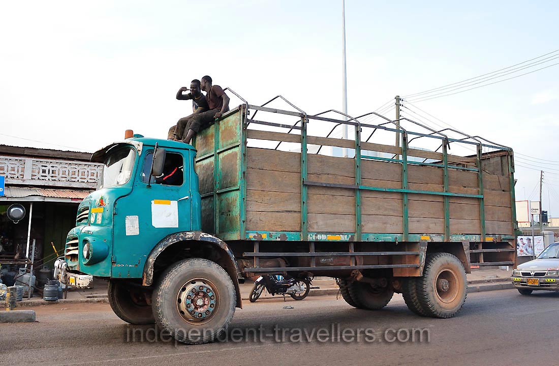 Funny guys from the roof of a truck demonstrate the welcoming gestures to me