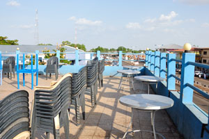 Tables and chairs are on the roof of Crest restaurant