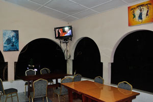 TV is mounted inside the cafe of Wli Water Heights hotel
