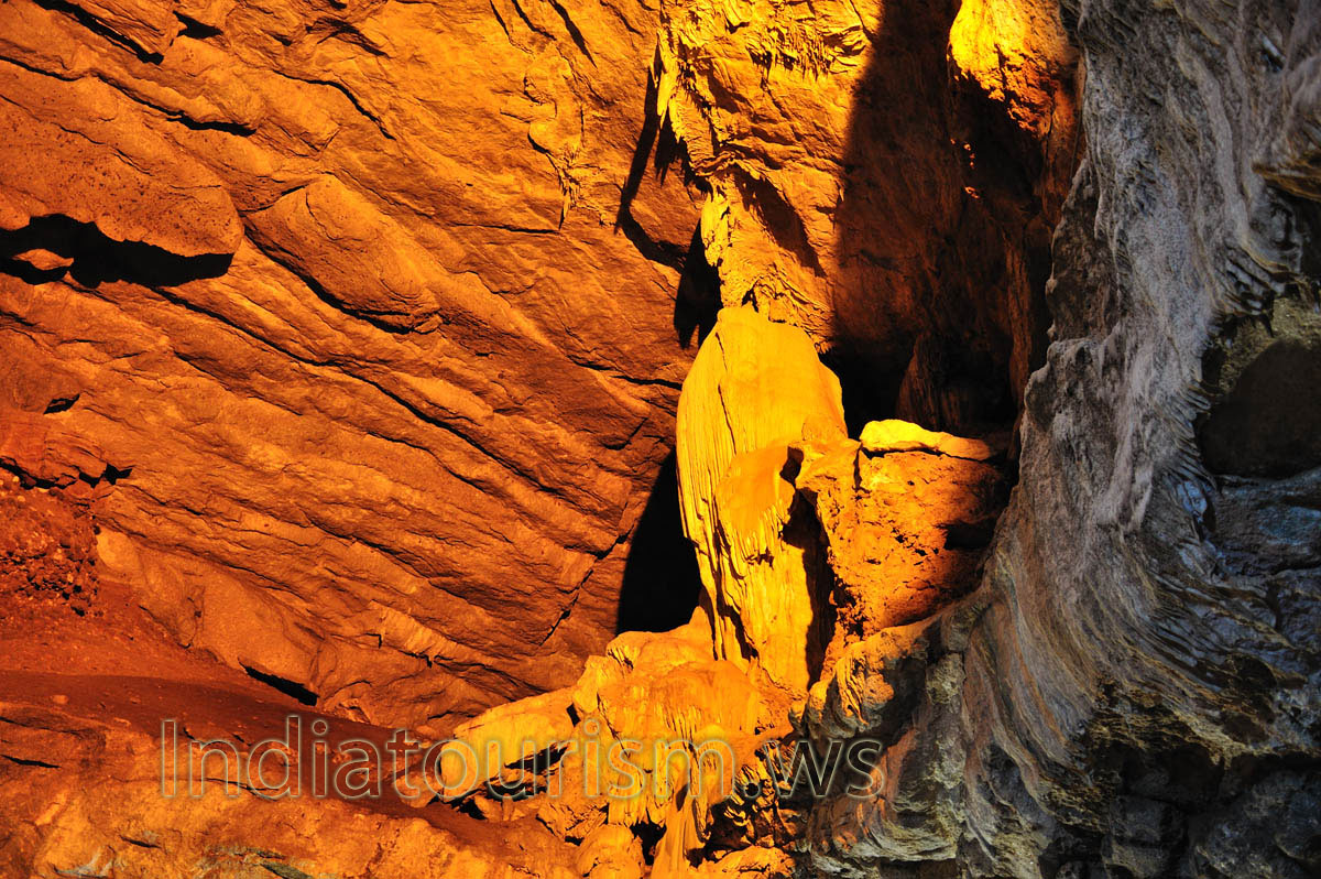 a group of small stalactites in the corner of the cave