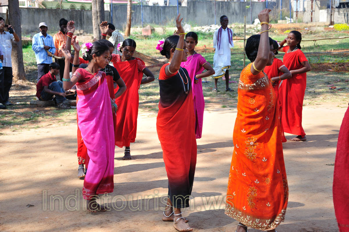 dancers are dressed in clothes of crimson and orange colors