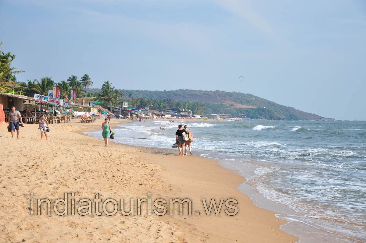 People walk along the seashore