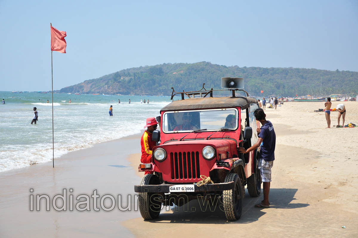 Lifeguard's jeep is beside the red flag