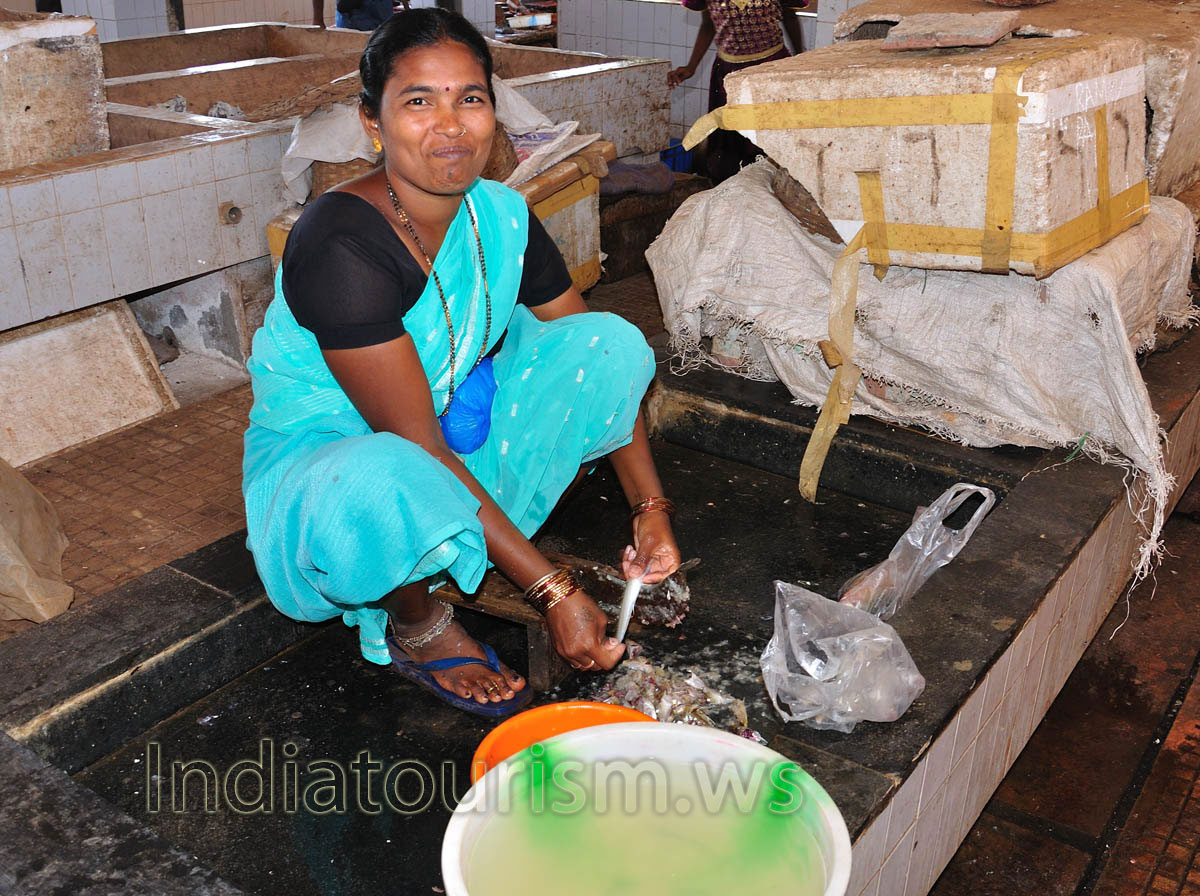 Fish Market: woman cleans fish