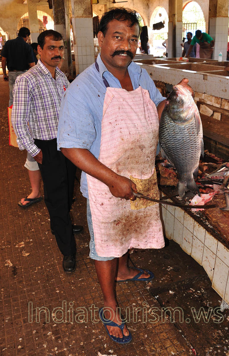 Fish Market: man with big fish and big knife in his hands