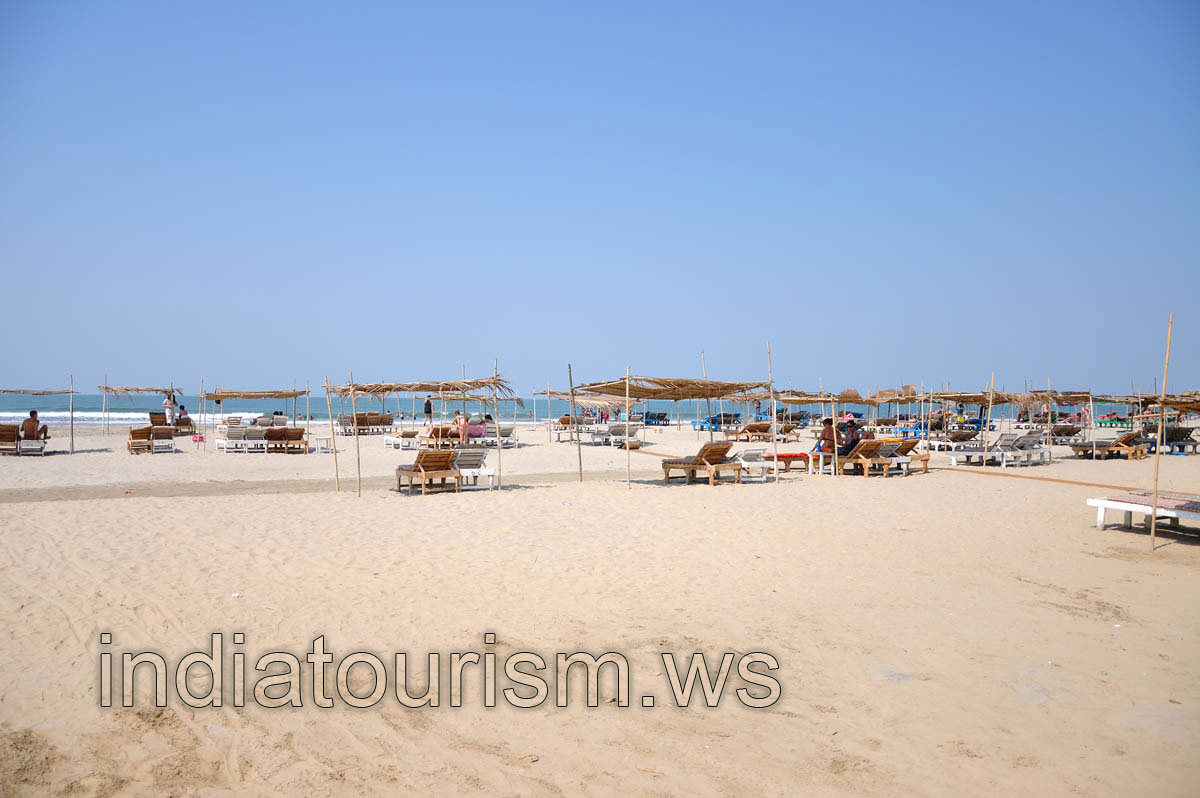 the sunbeds and their straw roofs