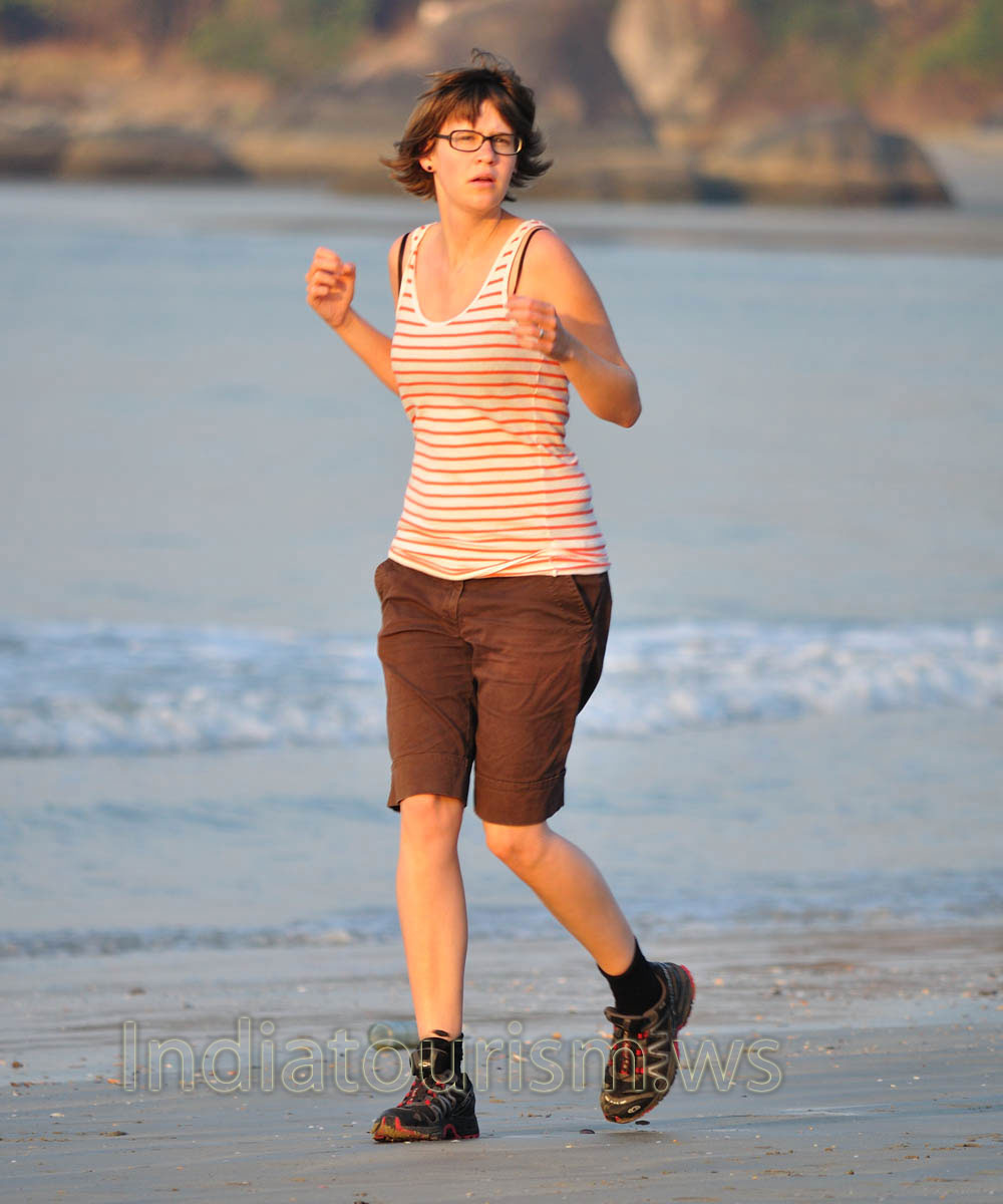 Woman running on the beach in the morning