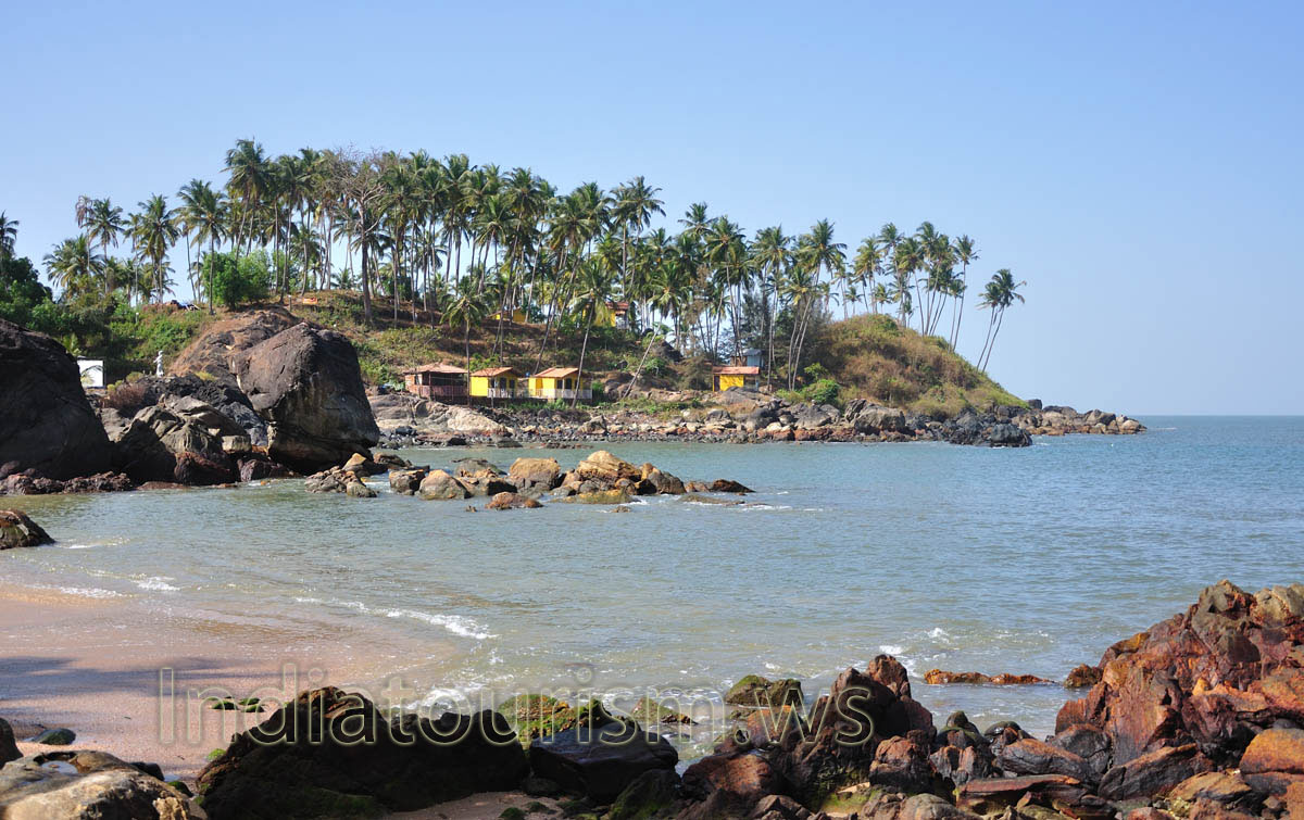 rocks and coconut palms on the southernmost tip of the beach
