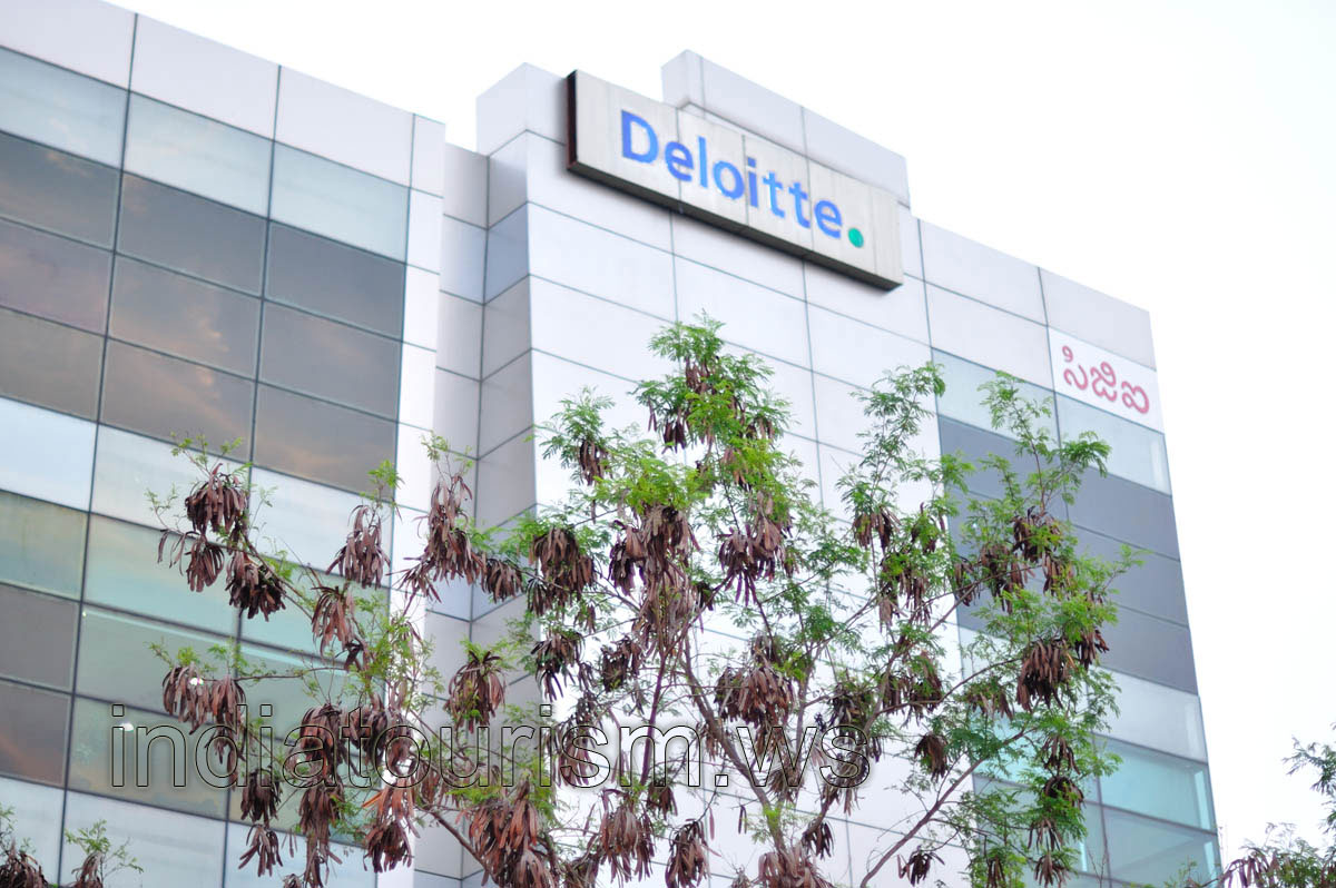 Deloitte - the name of the company at the top of the building