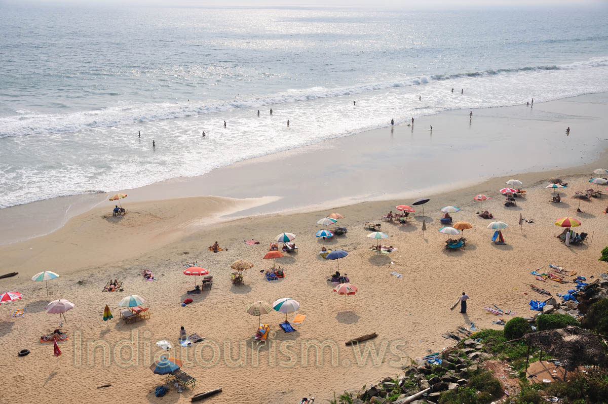 many parasols are set on the varkala beach in the evening before the sunset