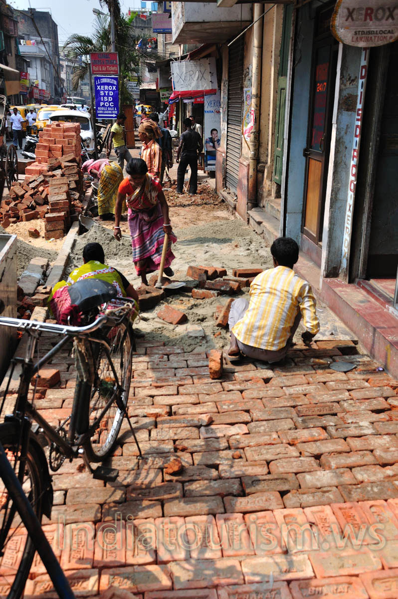 on one of the adjacent streets people are laid paving slab