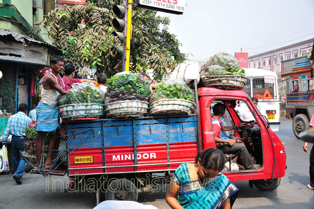 The truck is fully loaded with eggplant and peppers