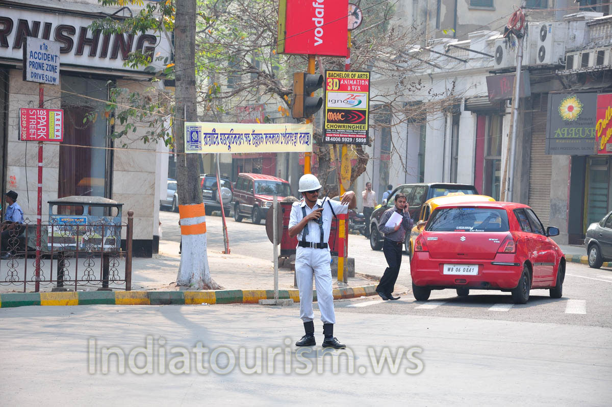 Policeman is talking by the radio at the crossroad