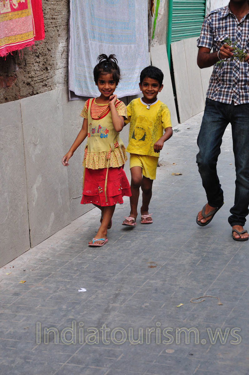 The little boy and the little girl are smiling