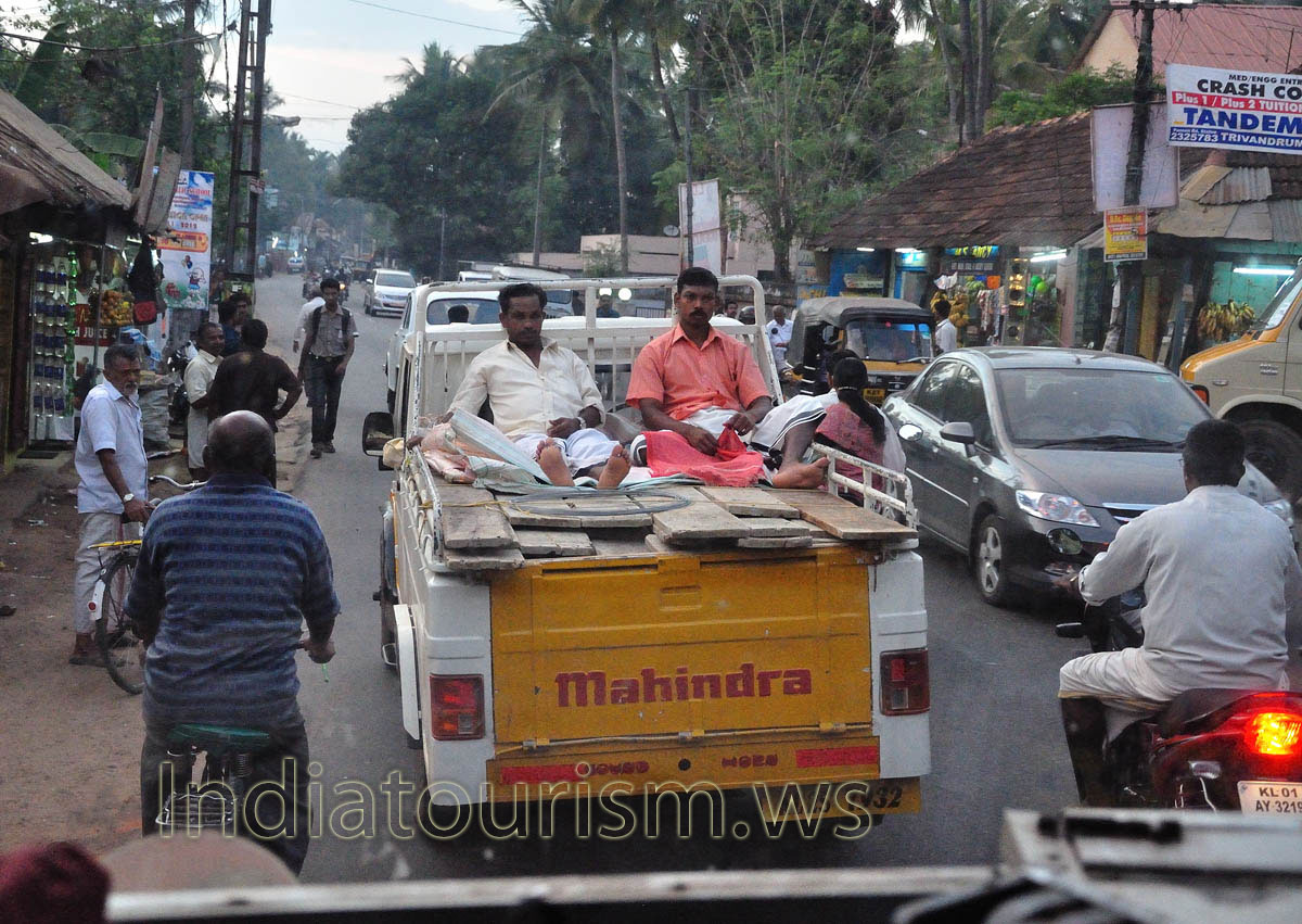 two man are meditating (joke) on the top of Mahindra truck on their way to Trivandrum