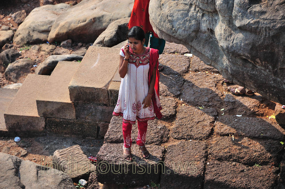 Indian girl calls to someone at the Udayagiri hill