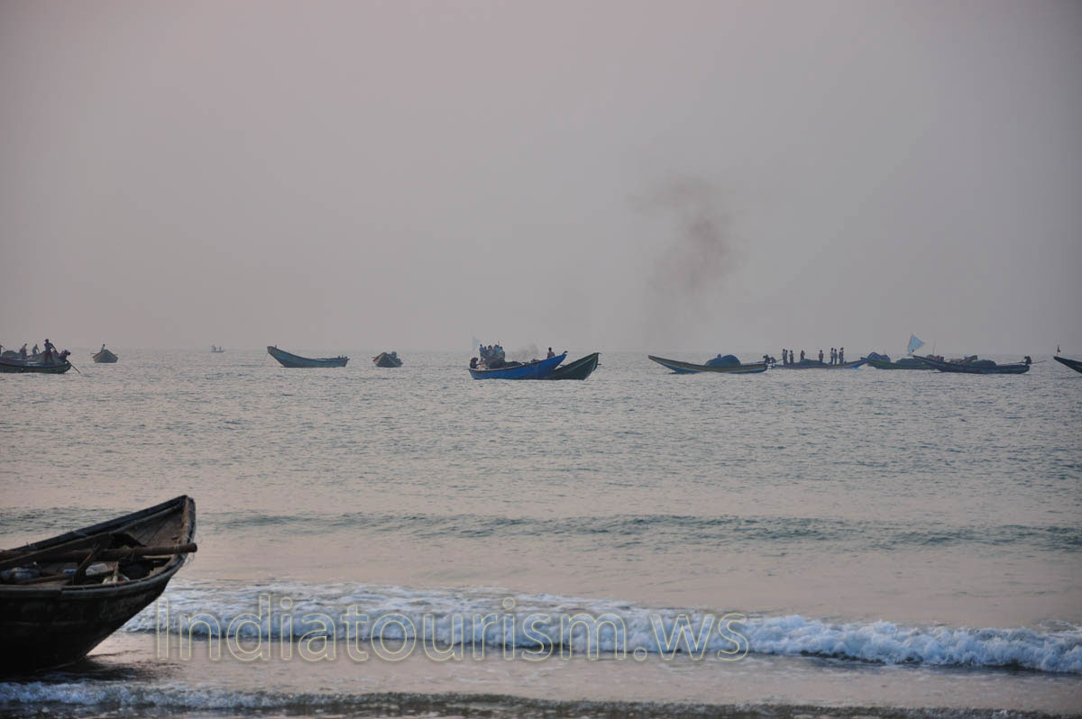 The smoke from diesel fuel rises above the boats of the fishermen