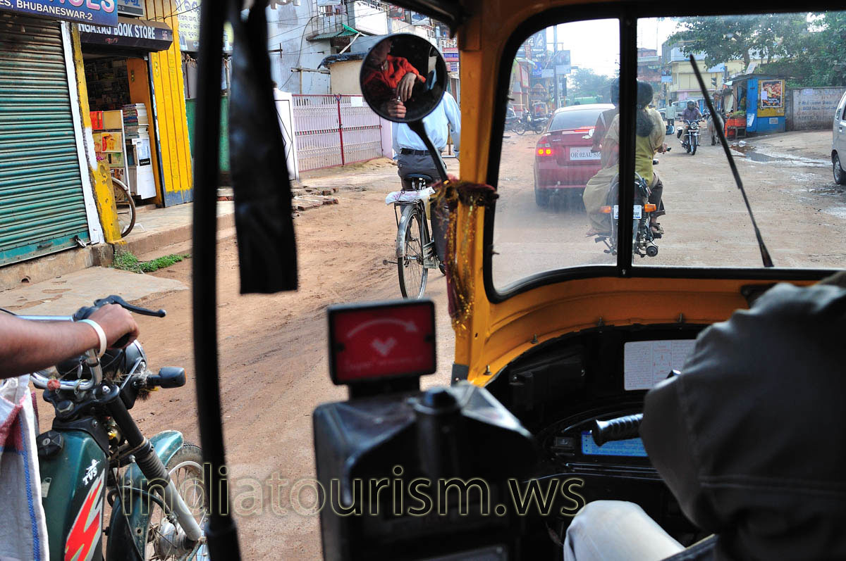 We drive through the streets of Bhubaneswar on auto rickshaw