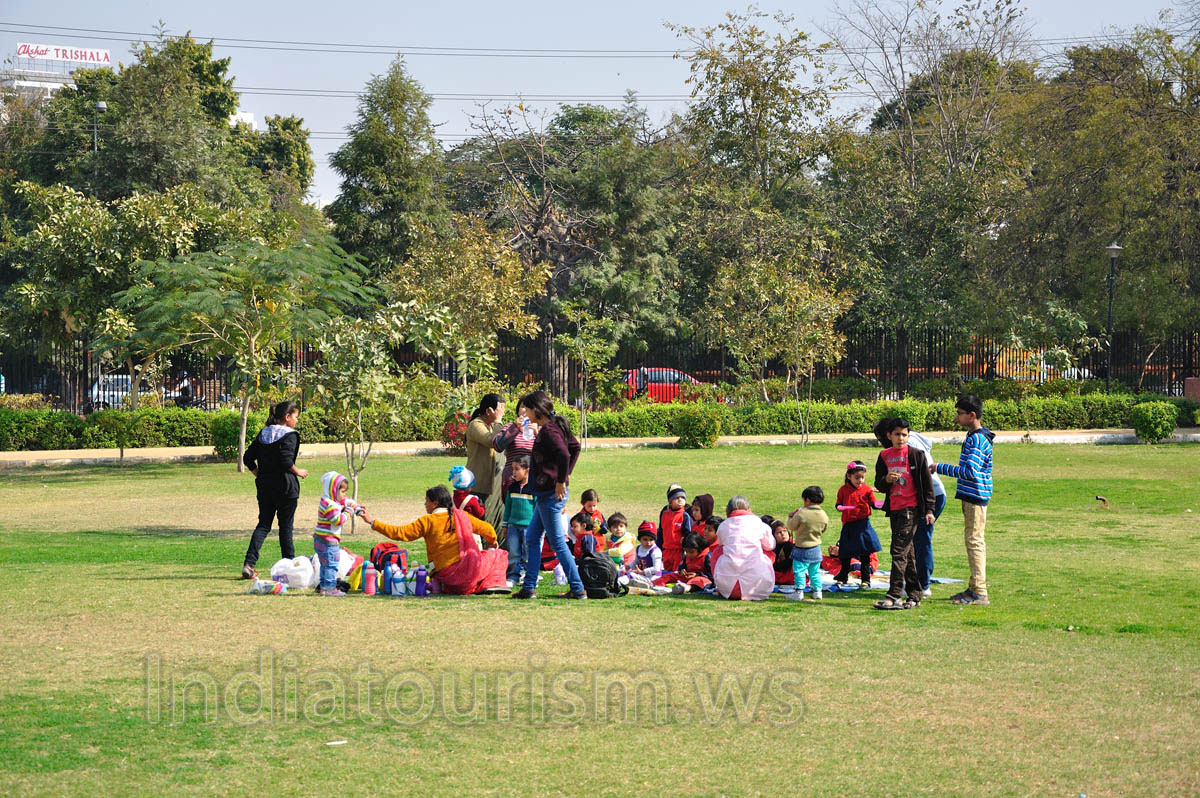 Indians with their children like to rest at the lawns of Central Park