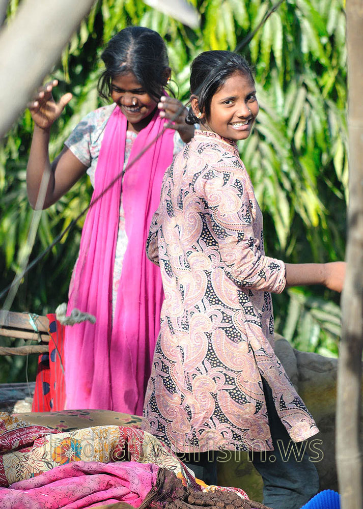 Teenage girls walk on the roof opposite our K.K. Palace hotel balcony