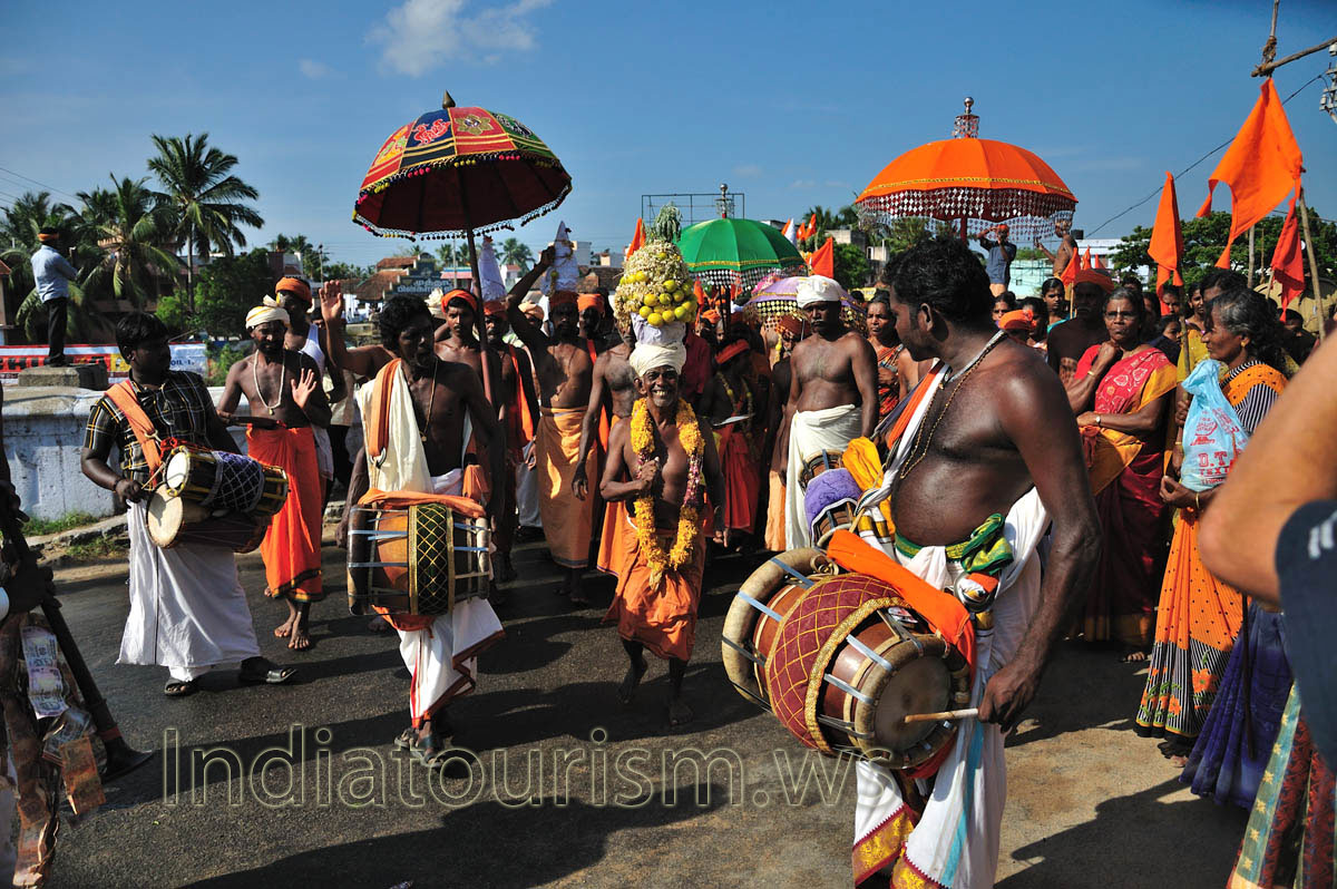 small man with big hat of fruits