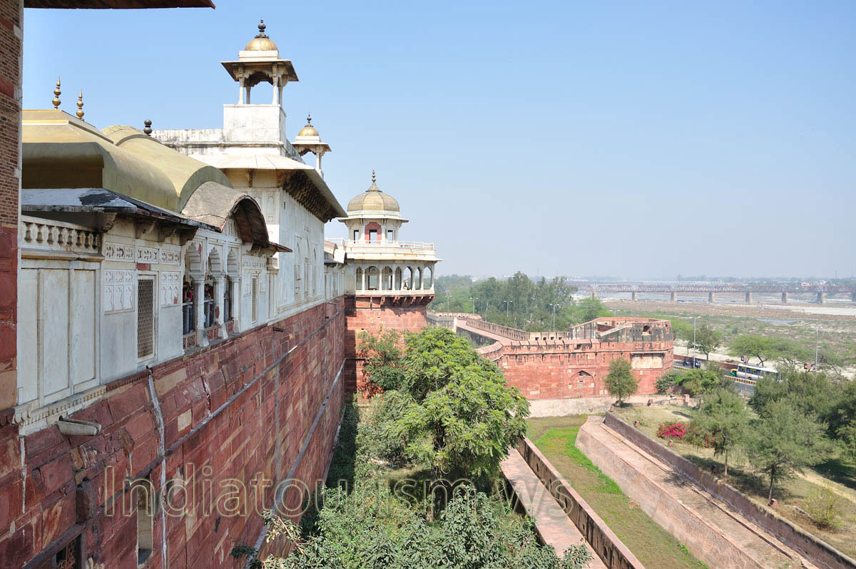 White and red structures of the fort, view of the railway bridge