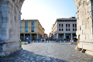 View of the historic city center through the Arch of Augustus