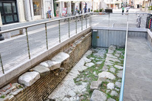 Ancient Roman ruins on the street of Via Quattro novembre