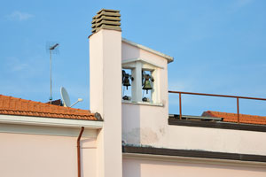 Small bells are on the roof of one of the buildings near the Via Bastioni Occidentali street