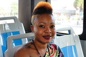 A lovely african girl is travelling by bus number 8