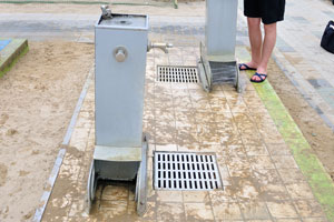 Foot-washing stations on the beach are equipped with drinking water taps