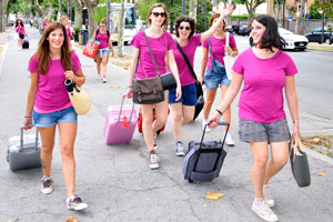 All beautiful young ladies are clothed in the same bright pink T-shirts