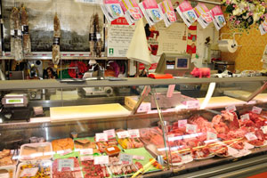 A counter with meat products and sausages at the central market