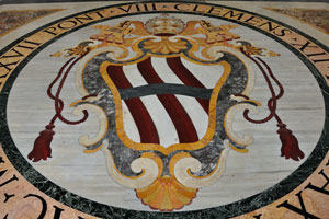 The coat of arms is on the floor in the portico of St. John Lateran