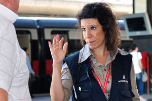 The woman in railway uniform is on the Roma Termini railway station